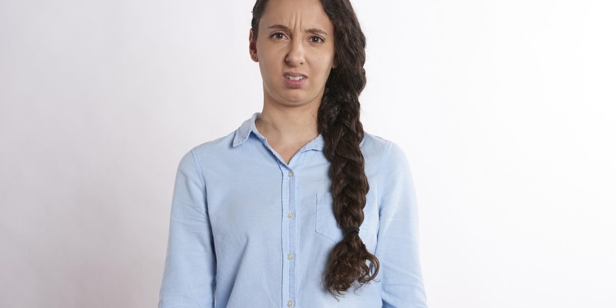 A student appearing confused or uncertain while reviewing university rankings.