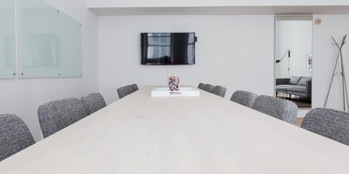 A young professional actively participating in an office meeting, gaining practical work experience.