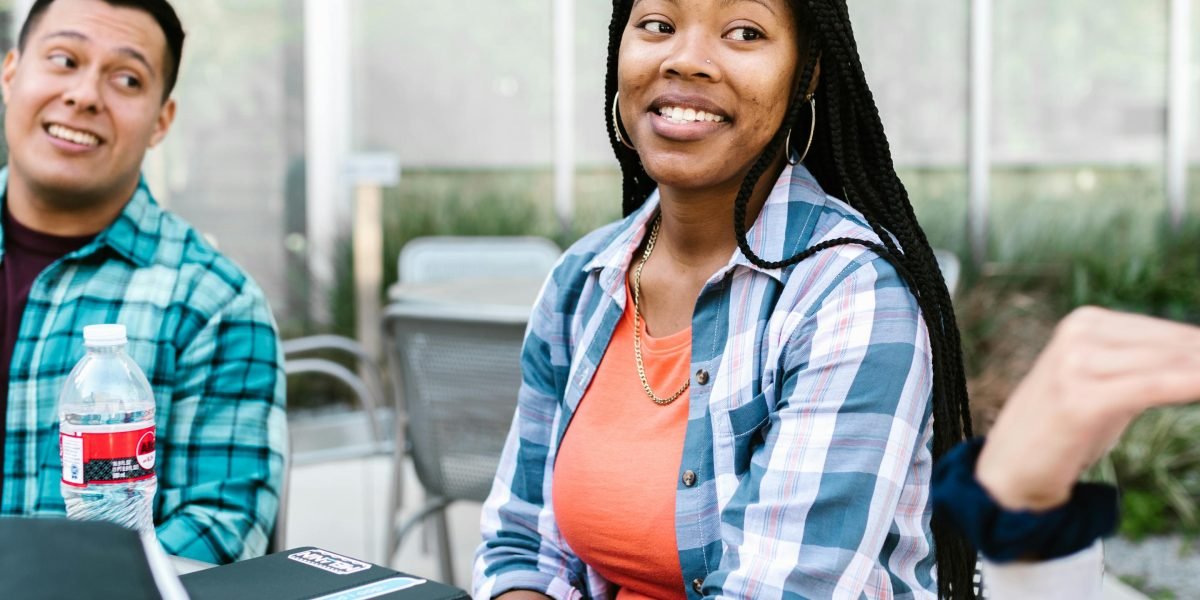 A student discusses college options with a mentor, considering factors beyond simple acceptance rates.