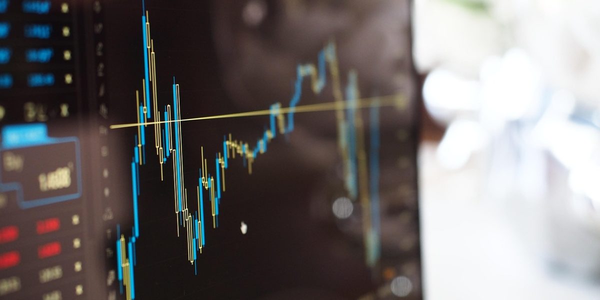 A person carefully analyzing charts and graphs, representing the study of college enrollment trends over multiple years.