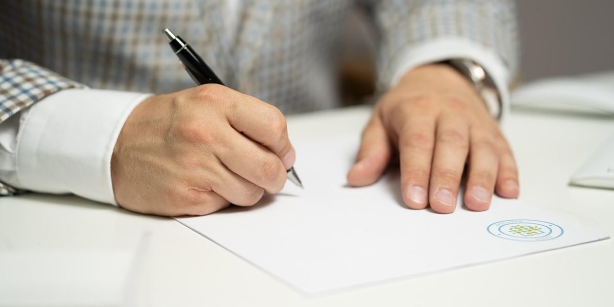 A student diligently organizes their documents for college applications, ensuring everything is in order.