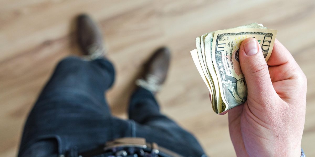 A student carefully reviews financial aid documents and plans for college expenses.