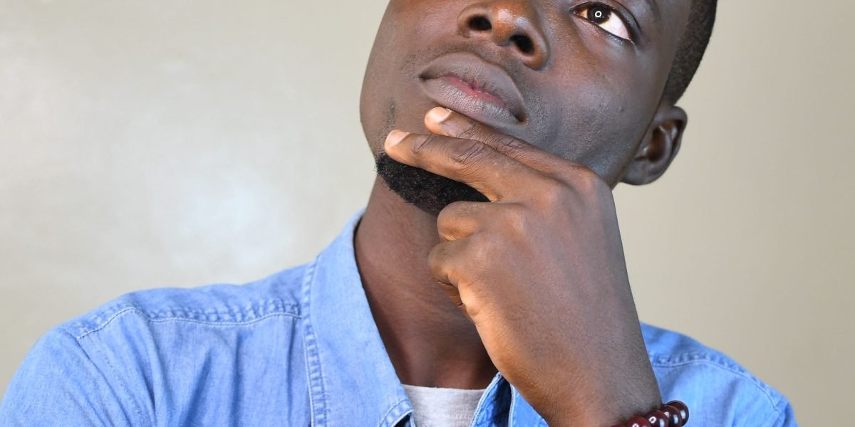 A student contemplating different college options, considering factors beyond just rankings.