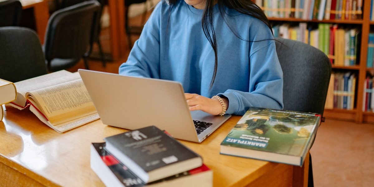 A person intently researching university profiles, weighing different options and information.