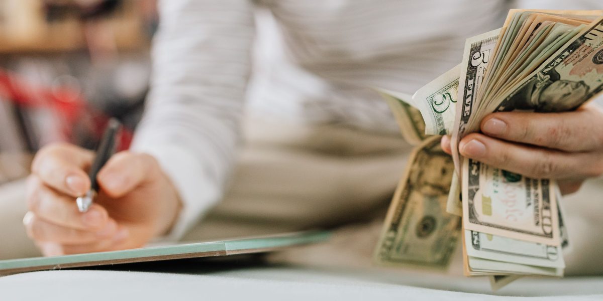 A person looking confident and relieved, possibly after securing financial aid or reviewing their budget.