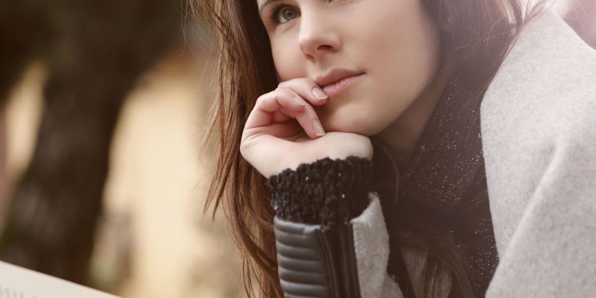A student thoughtfully considers their educational and career aspirations, weighing different pathways.