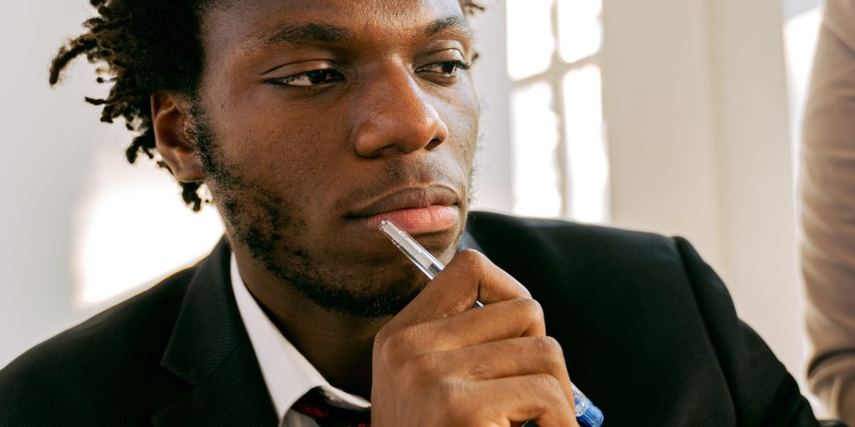 Someone reflecting deeply, indicating the careful consideration required for important career path decisions.