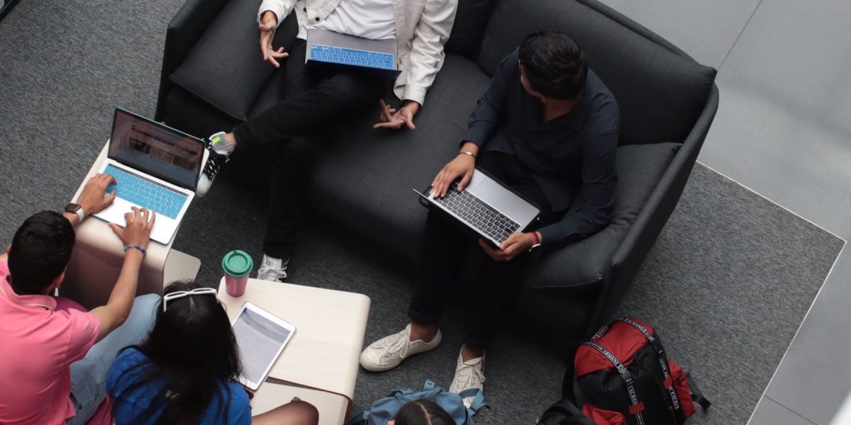 Students gather in a relaxed environment, engaging in intellectual discussion and creative collaboration.