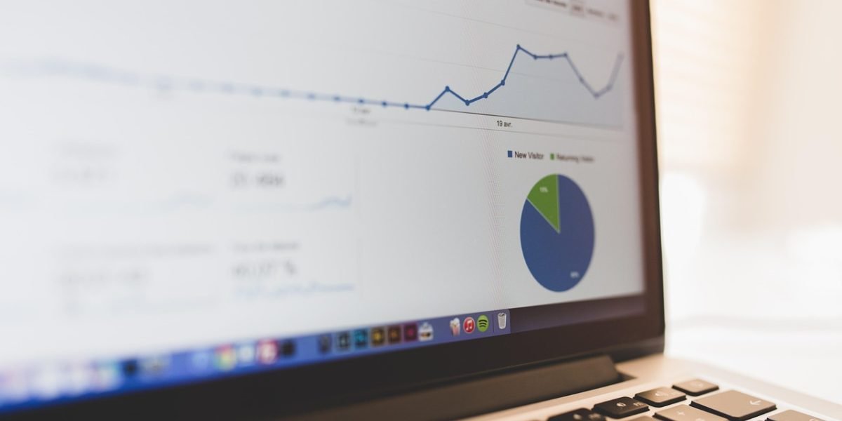 A person thoughtfully reviewing charts or reports, symbolizing the analysis of historical data and trends.
