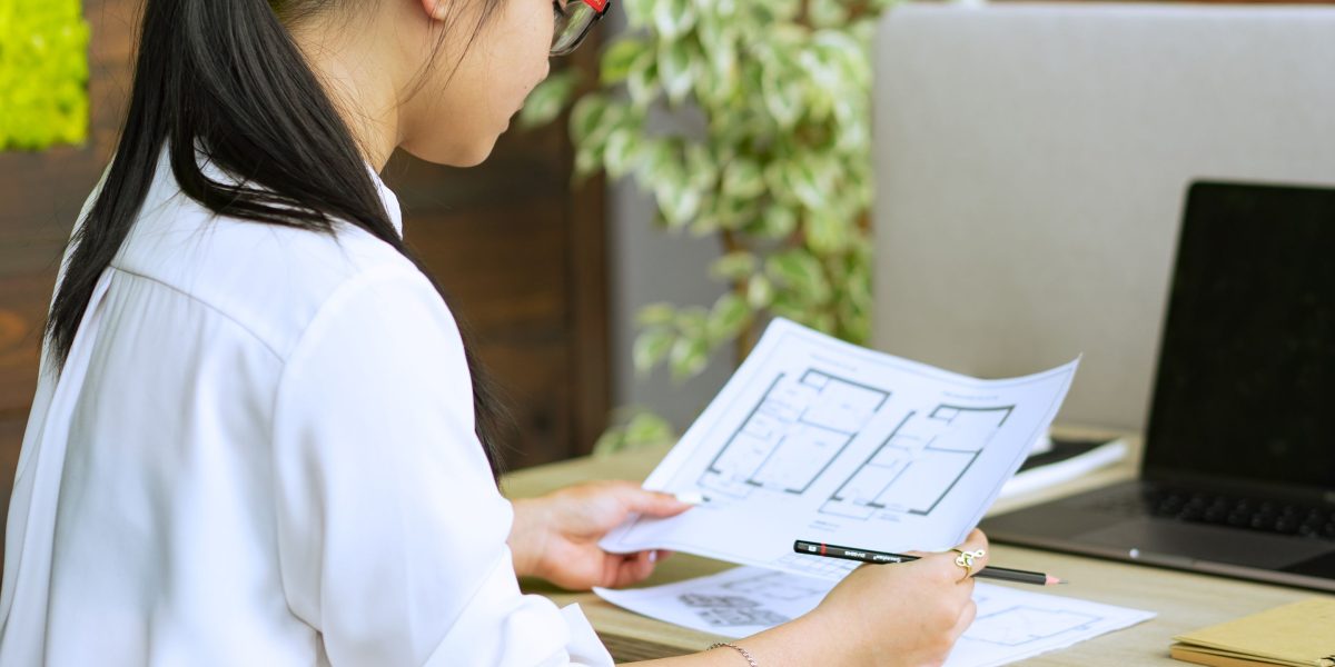 A student intently reviews various documents and data points, focused on making an informed decision.