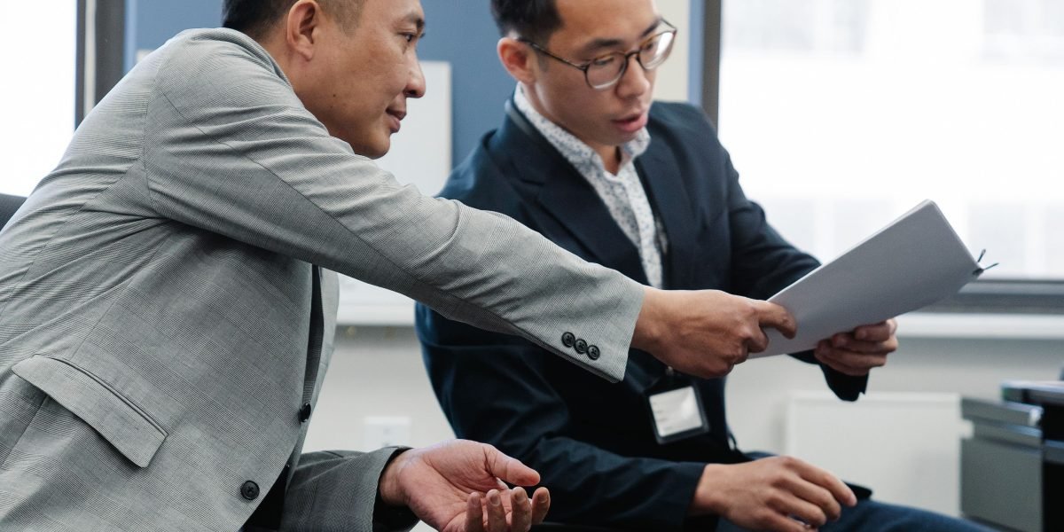 A student or professional receiving feedback on their resume from a career advisor.