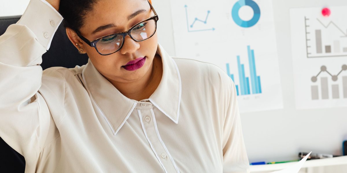 A student looks thoughtfully at a document, pondering complex information and making a significant decision.