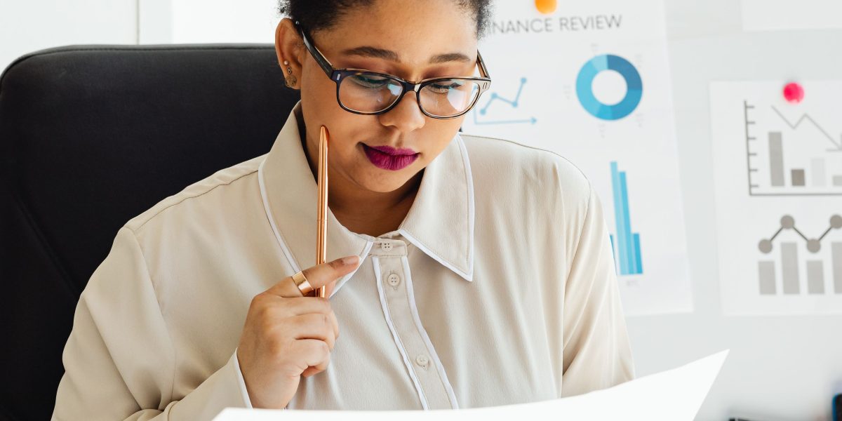 An individual diligently analyzing complex data and documents to make an informed decision.