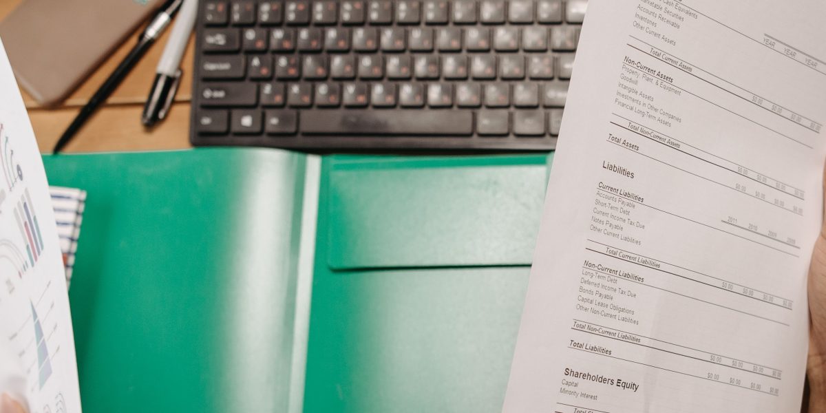 A student thoughtfully reviews multiple college documents, seeking deeper insights beyond initial acceptance rates.