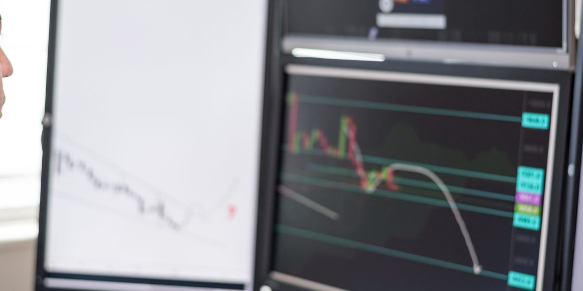 A person studies various data charts on a screen, using visual tools to uncover trends in complex information.