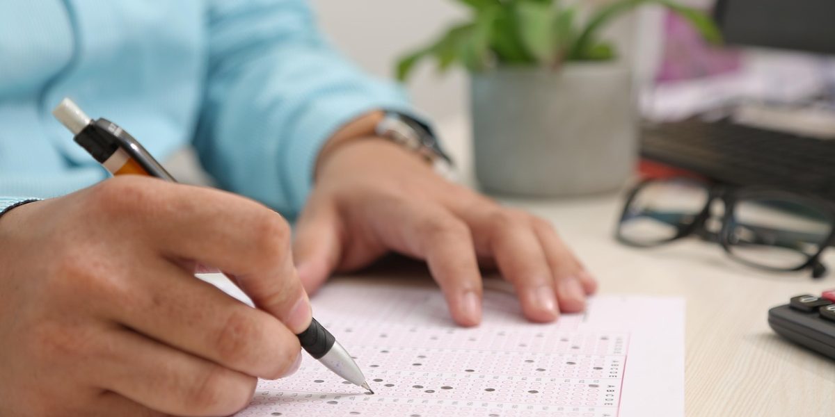 A person carefully completing an online application form for student finance, ensuring all details are accurate.