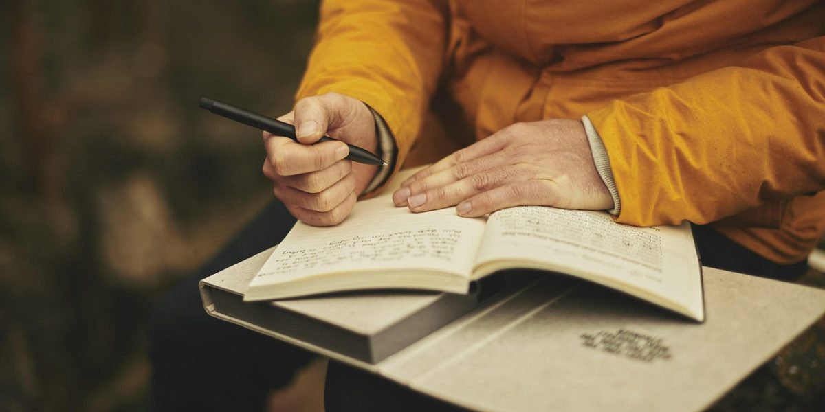 A student meticulously reviewing and comparing documents related to tuition fee loans and maintenance loans to understand their financial implications.
