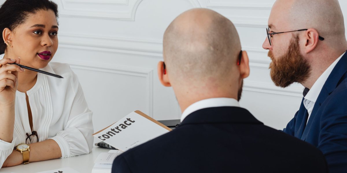 Professionals negotiating contract terms, ensuring clarity and understanding for a new software agreement.